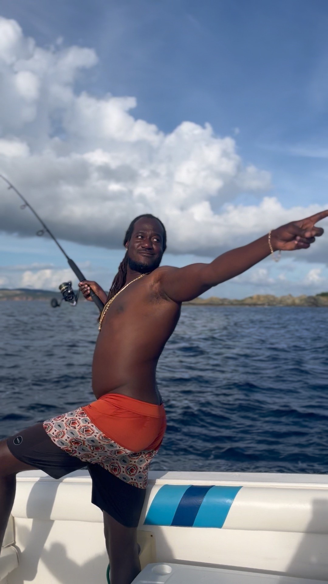 Lenroy with fishing rod on a boat