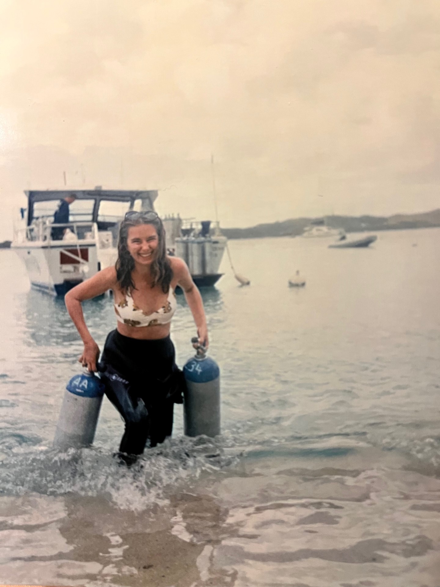 Savannah carrying scuba tanks to shore